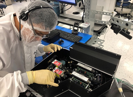 Optics technicians working on optical subassemblies.